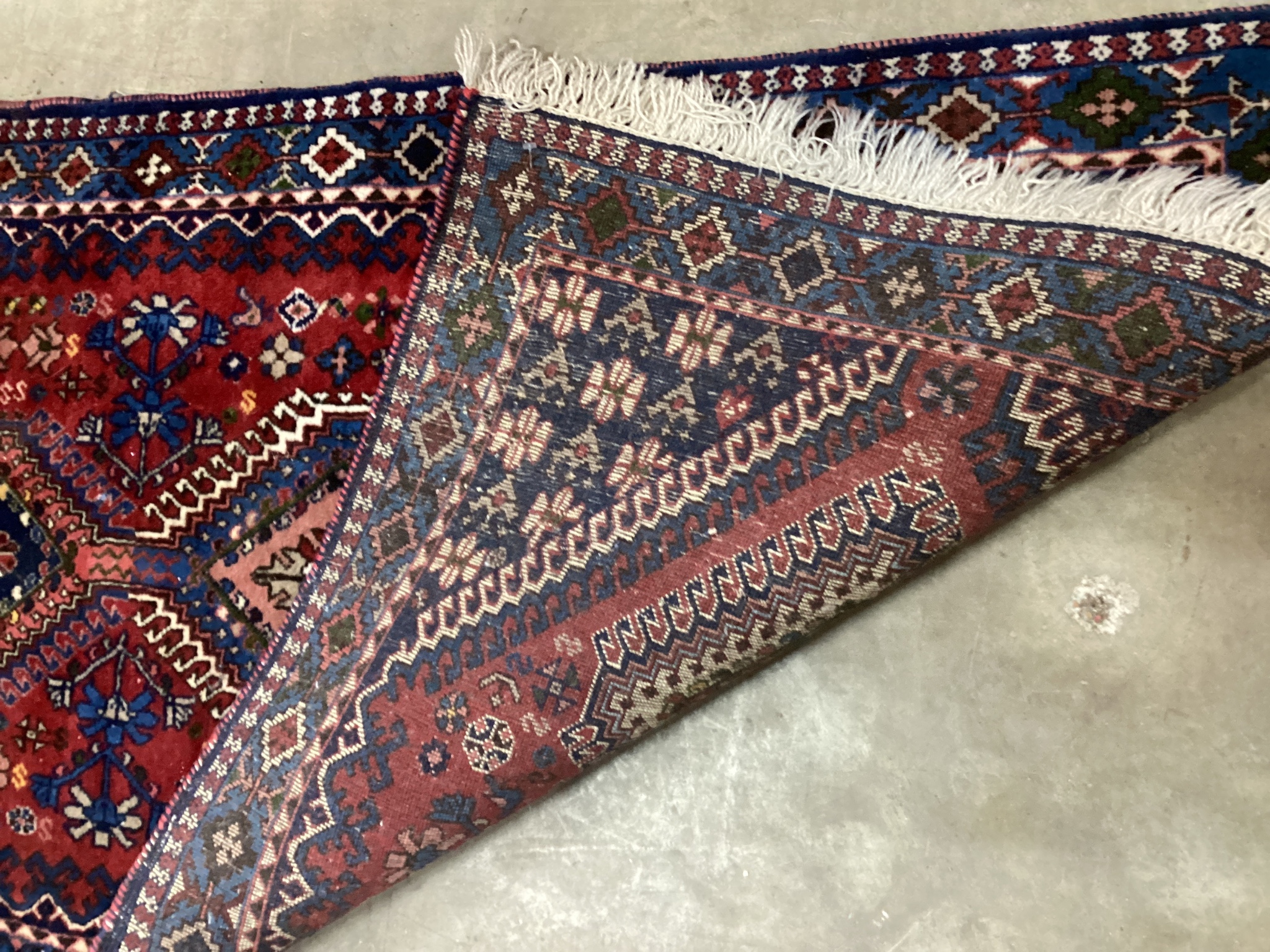 A Caucasian style red ground runner 200cm x 76cm